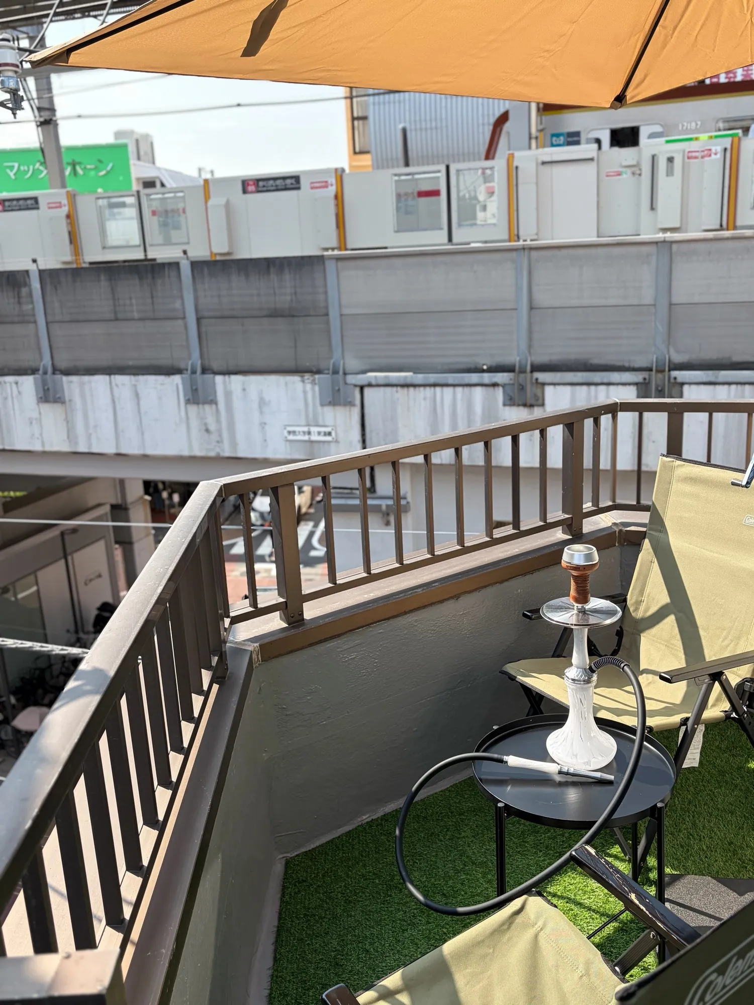 Parasol and seats on the terrace of shisha bar IORI on a sunny day
